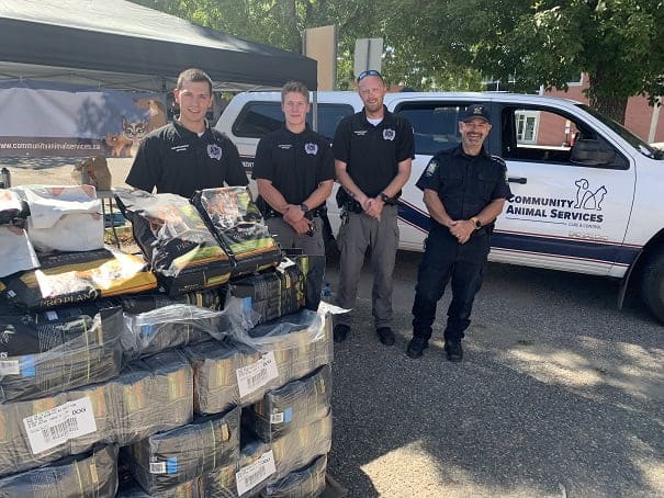 Alberta SPCA Peace Officers handing out Pet Food