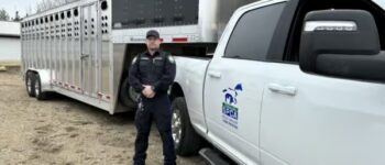 Peace Officer Luke standing in front of new stock trailer