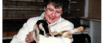 Woman named Joy Ripley holding a small goat with a joyful expression.