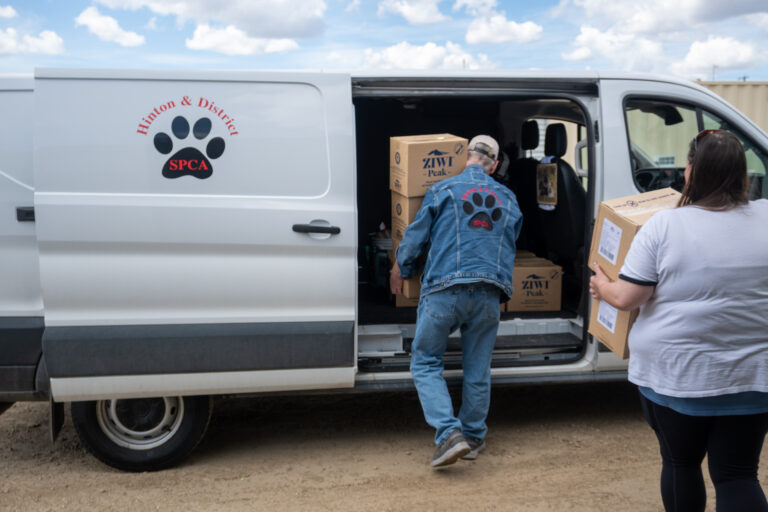 Alberta SPCA vehicle with volunteers loading supplies for animal rescue and care in Alberta.